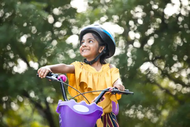 Photo of Carefree girl riding bicycle at park