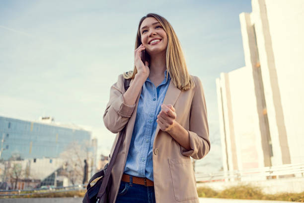 istock Businesswoman talking on phone smiling 1196820787