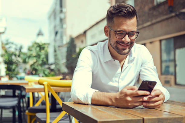 istock Businessman Texting on the Phone smiling 1196820924