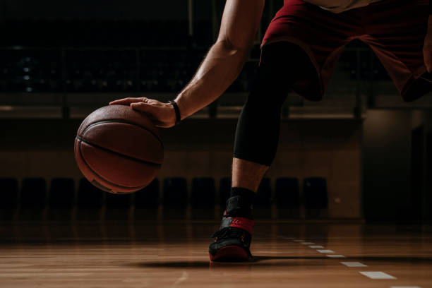 istock Basketball Player Dribbling a Ball 1196820940