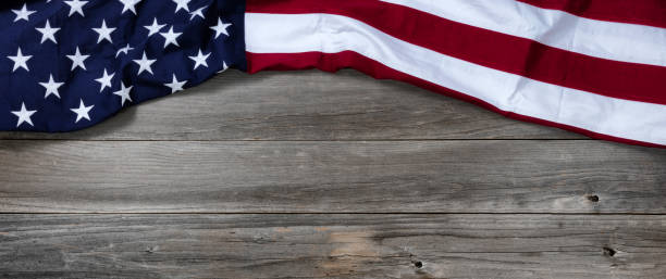 istock United States flag forming upper border on rustic wooden boards 1196828471