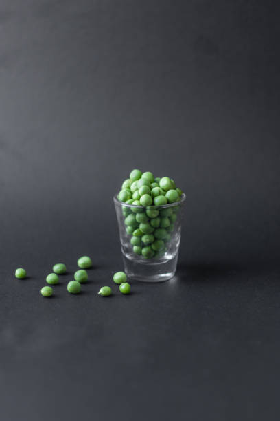 istock Healthy fresh green peas top view flat lay with black background. 1196833882