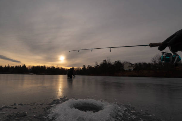 istock Ice fishing during sunrise 1196834063