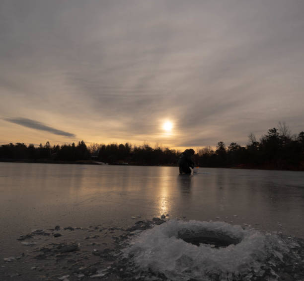 istock Ice fishing during sunrise 1196834627