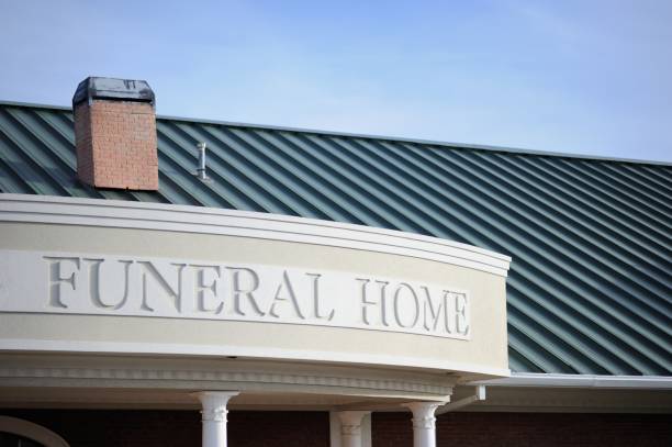 Funeral home sign on building Close up of funeral home sign engraved on curved building front with copy space above funeral parlor photos stock pictures, royalty-free photos & images