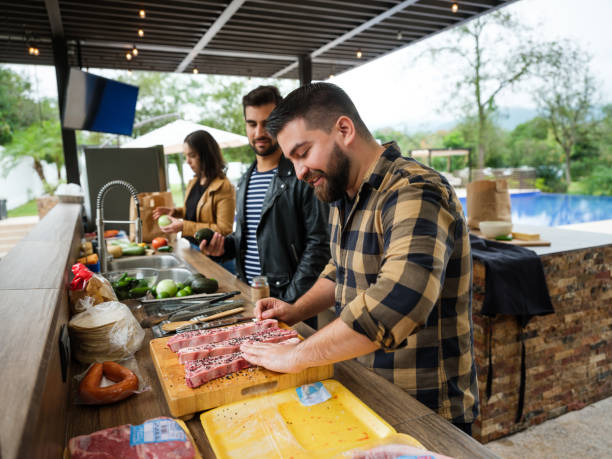 istock Friends cooking together in outdoor kitchen 1196836599