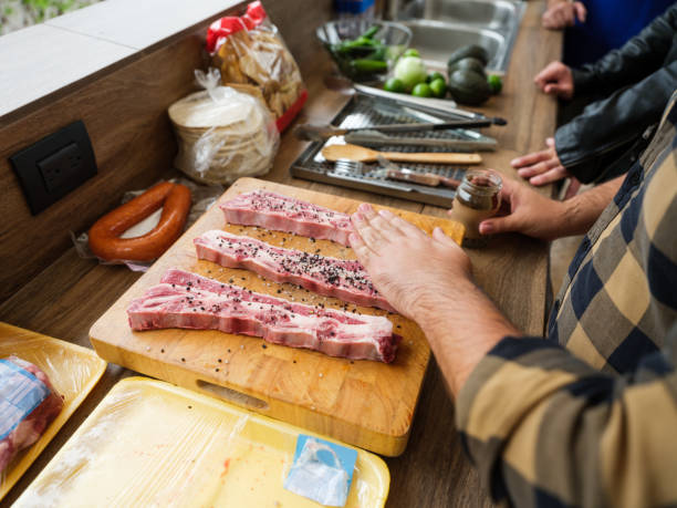 Close up of latin man preparing meat to make barbecue.