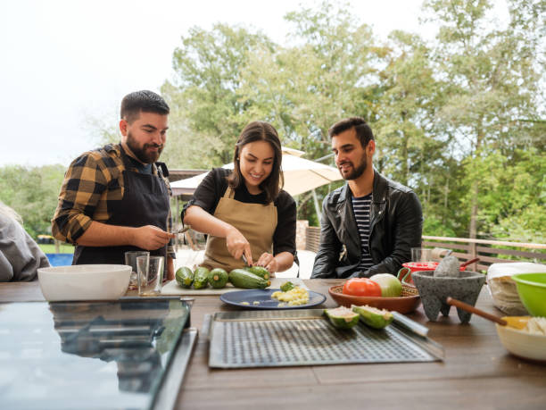 istock Group of friends cooking together 1196836653