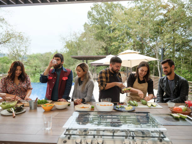 istock Friends cooking for a party next to pool 1196836683