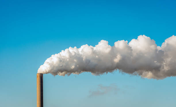 smoke and steam from a factory chimney - environmental damage power station factory smoke stack imagens e fotografias de stock