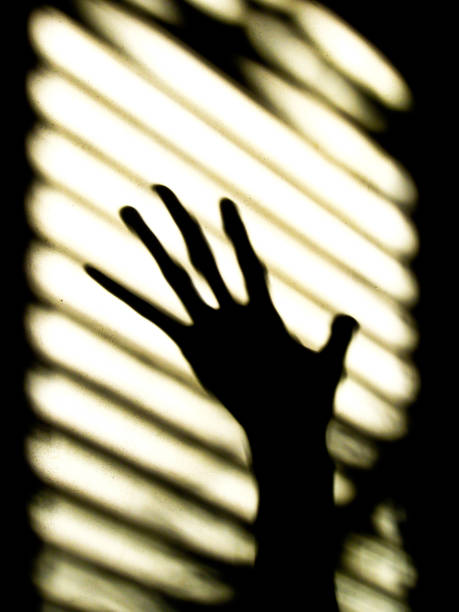 istock The shadow of hand  on the wall 1196839130