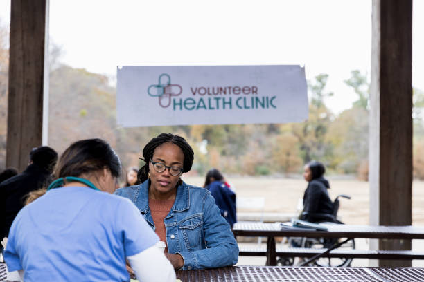istock Unrecognizalbe doctor documents patient information at free clinic 1196843539