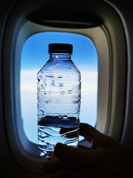istock The drinking water on the plane with the sky background 1196844757