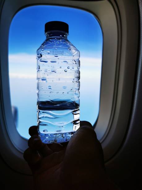 istock The drinking water on the plane with the sky background 1196844762