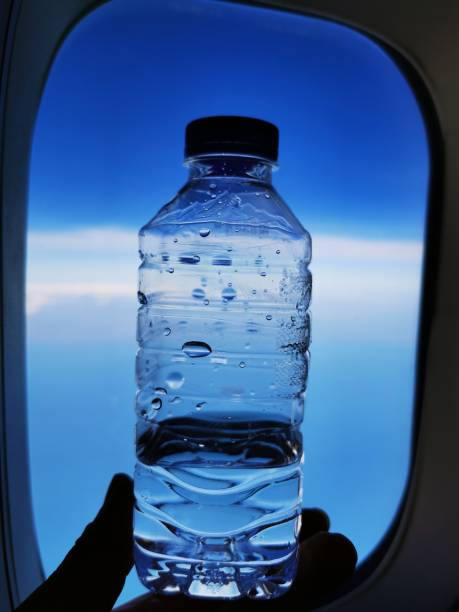 istock The drinking water on the plane with the sky background 1196844779