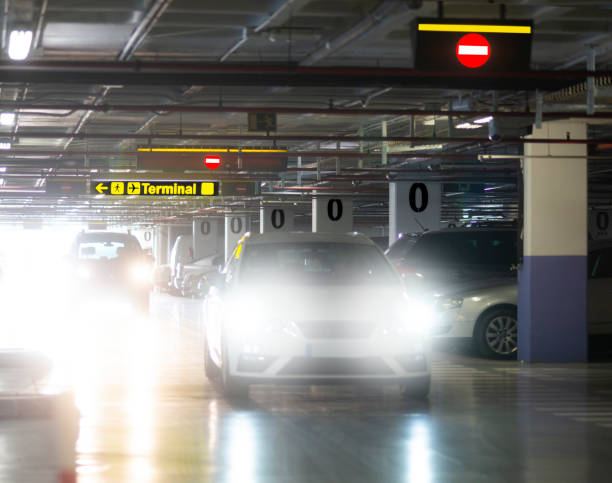 Indoor car park at airport, cars with blinding head lights