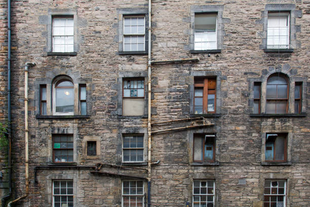 A tenement is a multi-occupancy building of any sort. In Scotland it refers to flats divided horizontally in an established building type, including desirable properties in affluent areas, but in other countries the term often refers to a run-down apartment building or slum.