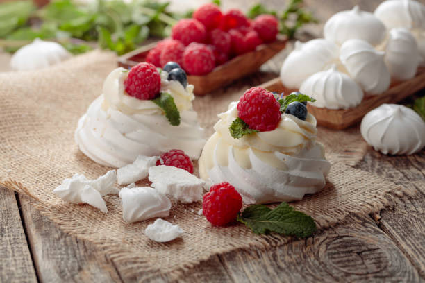 istock Pavlova and small meringues on a rustic wooden background. 1196848596