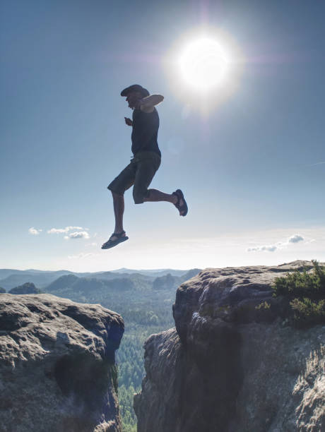 istock Personal challenge, risk and freedom. Crazy  man jumping over 1196856125