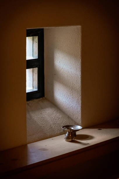 istock Through a window the sun shines on an old silver carafe and a plate 1196861092