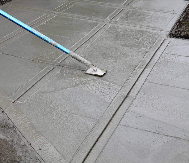istock Worker Putting The Finishing Touches On A New Sidewalk 1196874893