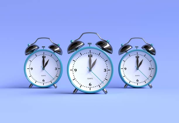 istock Alarm clocks on a blue background - 3 pieces - 3D rendering 1196879765