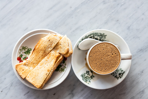 Overhead view of traditional Chinese coffee and toast bread at kopitiam, popular breakfast combination in Malaysia