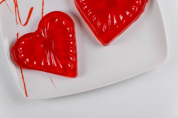 istock Two hearts made from strawberry gelatin on white plate. 1196888432