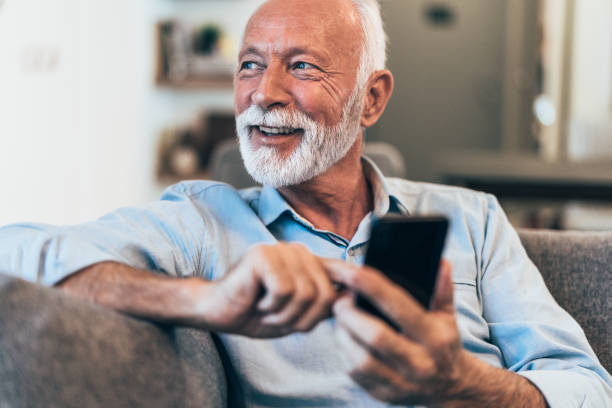 texting - beard senior men looking away smiling стоковые фото и изображения