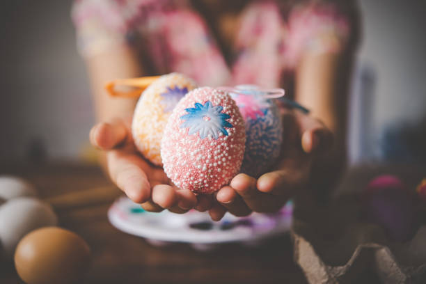 istock young girl painting Easter eggs for eastertime at home 1196888495