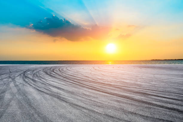istock Empty race track and lake with colorful clouds at sunset. 1196891459
