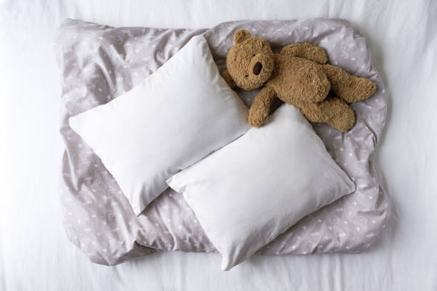 istock Two Blank White Pillows On a Patterned Grey Background With Teddy Bear Mockup - Styled Stock Photography - Twin Cushions Flat Lay Mockup - Nursery Pillowcases Mockup 1196892201
