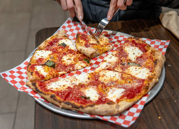 istock Cutting slice of cheese pizza 1196898178
