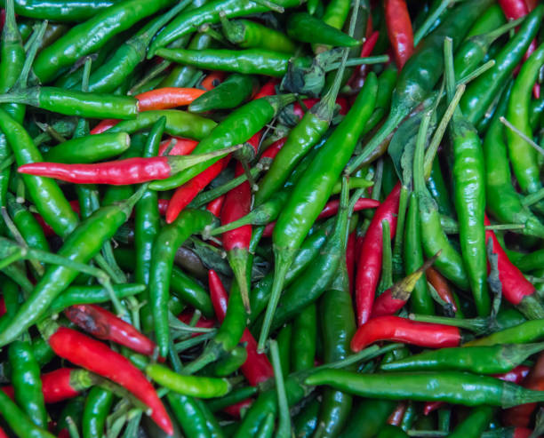 istock close-up red and green Thai chili peppers. 1196898791