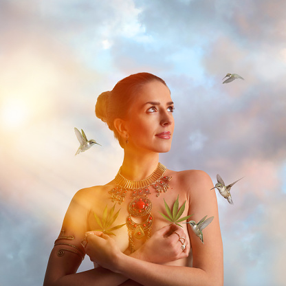 Multiple Exposure of a Health conscious young woman holding hemp leaves with hummingbirds