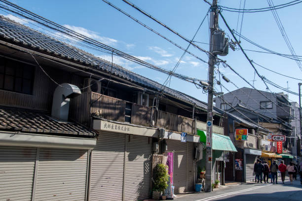 People are walking on street toward Shitennoji in Osaka Tennoji area. Osaka, Japan- 01 Dec, 2019: People are walking on street toward Shitennoji in Osaka Tennoji area. shitenno ji stock pictures, royalty-free photos & images