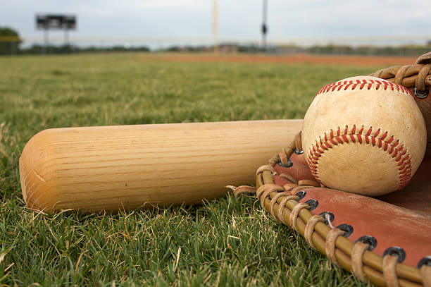 istock Baseball, bat, and glove on the grass 119691585