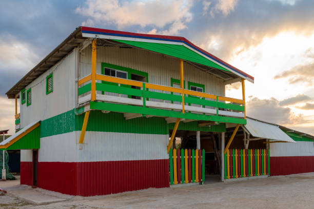 Colorful beach Restaurant and Bar/ Club painted in Jamaican rasta colors of red, gold, green on Caribbean island Colorful beach Restaurant and Bar/ Club painted in Jamaican rasta colors of red, gold, green on Caribbean island. Sunset in background. falmouth harbor stock pictures, royalty-free photos & images