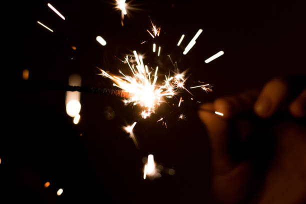 istock Hand in the dark holds a sparkler. Bengal fire. 1196917927