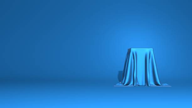 istock Abstract podium, pedestal. A tall cube is covered with shiny fabric. Stylish minimal abstract horizontal scene, place for text. Trendy classic blue color. 3D rendering 1196922902