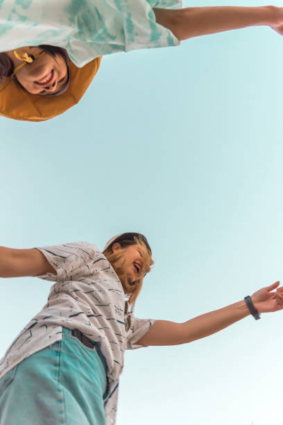 istock Women hold hands circle happy running round camera 1196924112
