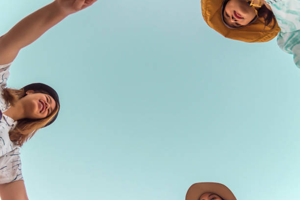 istock Women hold hands circle happy running round camera 1196924165
