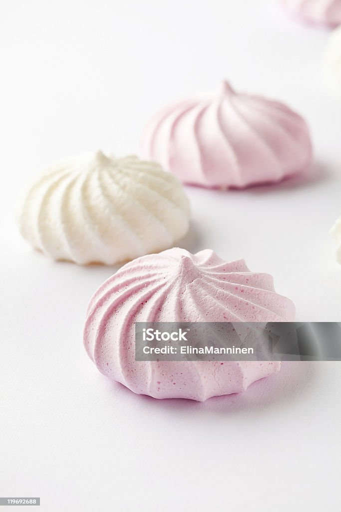 Three pastel colored meringue drops on a white background Pastel colored meringue on a white background Candy Stock Photo