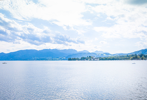 Panoramic view of mountains behind Schloss Ort, medieval castle on Traunsee lake, Salzkammergut, Austria