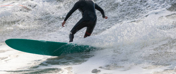 istock a surfer surf a wave in italy 1196935497