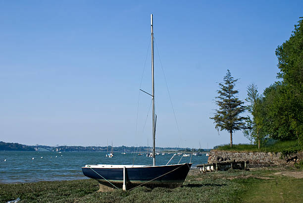 Sailboat sails around a rock in the atlantic ocean