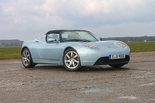 Warsaw, Poland – November 18th, 2009: Zero emission Tesla Roadster (2008-2012) stopped on a road. The Roadster model is the first vehicle from Tesla brand. This model is also the first car in space.