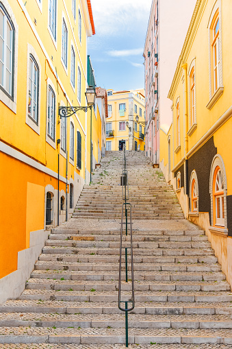 Stairs of the colorful street Travessa da Arrochela on a sunny day in summer. Travel concept. Lisbon, Portugal. Europe.