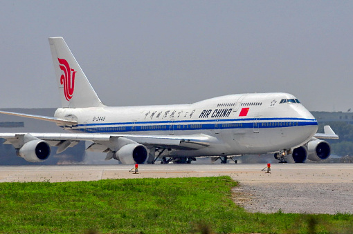 Beijing, China-July 9, 2009: Airplanes were taxing, landing or taking off in Beijing Capital International Airport. This is a Boeing 747-400 aircraft of Air China.