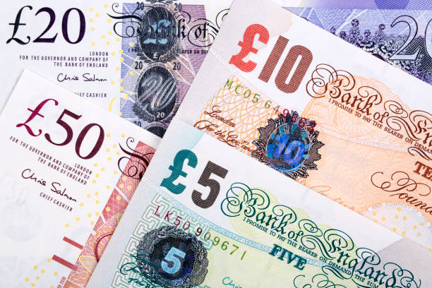 british pounds a business background - nota de pound britânico imagens e fotografias de stock